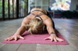 © Westend61 - Woman doing relaxation exercise on mat in yoga studio