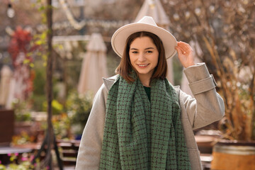 Poster - Beautiful woman in warm scarf and hat outdoors