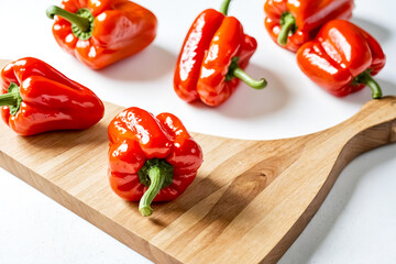 Wall Mural - Red Bell Peppers on a Wooden Cutting Board