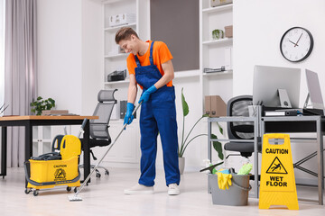 Poster - Cleaning service worker washing floor with mop. Bucket with supplies and wet floor sign in office