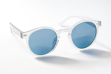 Wall Mural - Clear Sunglasses with Blue Lenses on White Background