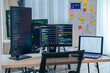 © weedezign - Software development office Workstation setup with multiple monitors displaying code and development diagrams during a nighttime coding session