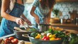 © nopommajun - Two women actively engage in cooking a fresh and healthy dinner in a modern kitchen setting