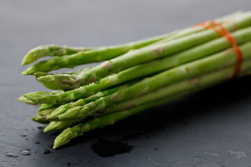 Wall Mural - Fresh green asparagus bunch on wooden table.