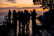 © Sunshine Seeds - Silhouette of people socialising on wooden deck at sunrise