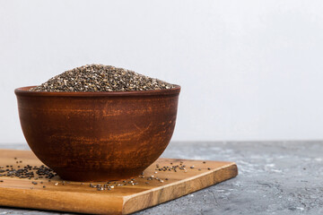 Poster - Chia seeds in bowl on colored background. Healthy Salvia hispanica in small bowl. Healthy superfood