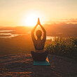 © Vincent - A person practicing yoga at sunrise on a beach or mountain, with a meditation or sun salutation posture, surrounded by nature.