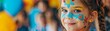 © pawimon - Birthday Face Painting Focus on a child getting face paint, with everyone smiling and looking at the camera, with a party background, empty space center for text