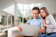 © BillionPhotos.com - Happy young couple with laptop relaxing at home.