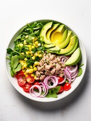 Wall Mural - A colorful bowl of mixed greens topped with sliced avocado, corn, tomatoes, and crispy lettuce