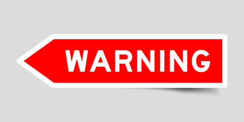 Sticker - Red color arrow shape sticker label with word warning on gray background