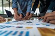 © Bruno Mazzetti - Business team collaborating on data analysis, reviewing charts and graphs in a modern office setting.