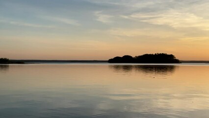 Wall Mural - Sunset over the lake. Awesome Sunset with dramatic clouds  in the sky over sea. Lake in wild nature. 