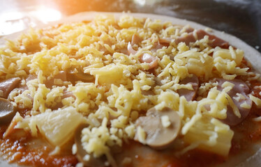 Sticker - pizza with sausage, cheese and mushrooms on the table