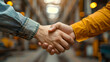 © jay juan - Close-up of hands in denim jacket shaking hands in agreement