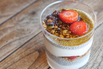 Wall Mural - Healthy Chia Pudding with Granola and Strawberries served in a transparent glass