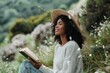 © Dina - diverse beautiful woman reading a book in nature among green plants as self care daily practice and 'me time'. Self love concept and therapy.
