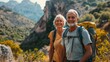 © BOONJUNG - Adventurous Senior Couple Embracing Nature on a Mountain Hike.