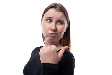 Wall Mural - Portrait of an upset schoolgirl with blond hair in a black turtleneck on a white background