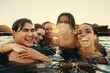 © Jacob Lund - Best friends enjoying a fun day abroad in a swimming pool at sunset