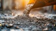 © Gasspoll - Fresh concrete pouring from mixer on construction site with sandy background