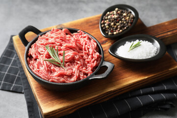 Wall Mural - Raw ground meat in bowl and spices on grey table
