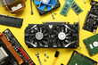© New Africa - Graphics card and other computer hardware on yellow background, flat lay