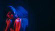 © golubovy - Vulnerable woman. Defocused silhouette. Lonely sad female depression insecure mental covering neon red blue double exposure empty space out of focus.