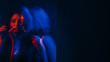 © golubovy - Mental pain. Defocused silhouette. Silent woman hearing voices neon red blue hands listening inner headache double exposure empty space out of focus.