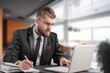 © BillionPhotos.com - Smiling busy professional businessman work on laptop