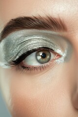 Wall Mural - closeup shot of woman eye iris and creative silver makeup with dye and paint, macro of cosmetics makeup, beauty and fashion