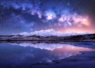 Wall Mural - bright milky way over snowy mountains and sea coast at winter night. landscape with snowy rocks, sta