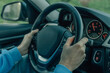 © carballo - close-up young man's hands on the steering wheel driving