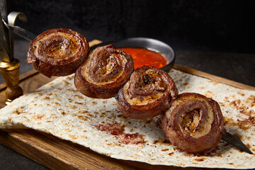 Wall Mural - Delicious Grilled Beef and Fat Lamb Skewer Rolls on Lavash with Spicy Red Sauce