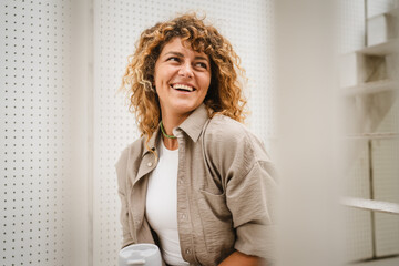 Portrait of adult woman sit at the stairs and smile enjoy the moment