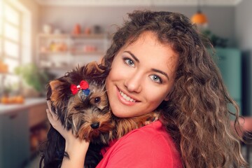 Canvas Print - young girl hold hug cute dog at home