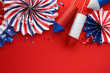 © photoguns - American federal holidays celebration concept. Flat lay composition with festive paper fans and firework rockets on red background.