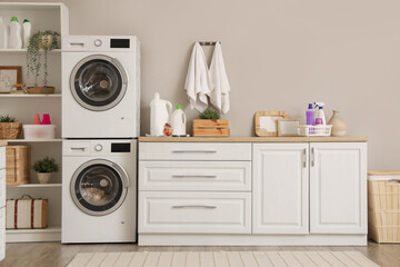 Poster - Interior of modern laundry room with washing machines and cleaning supplies