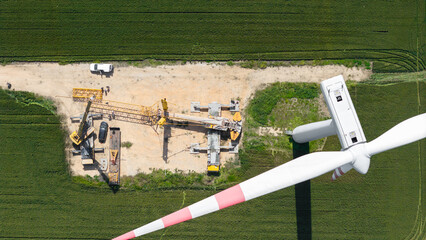 Wall Mural -  crane get ready for lifting a wind turbine, renewable energy and power, zero carbon footprint