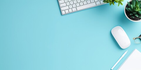 Minimalistic composition: Web design studio concept page on the screen, with a keyboard and mouse beside. The flat lay composition includes a blue desk and emphasizes the importance of digital rende