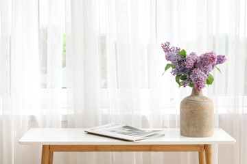 Canvas Print - Vase with lilac flowers on table near light curtain in living room