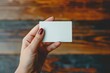 © Olena - Person Holding Credit Card. Blank Business Card for Mockup with White Background