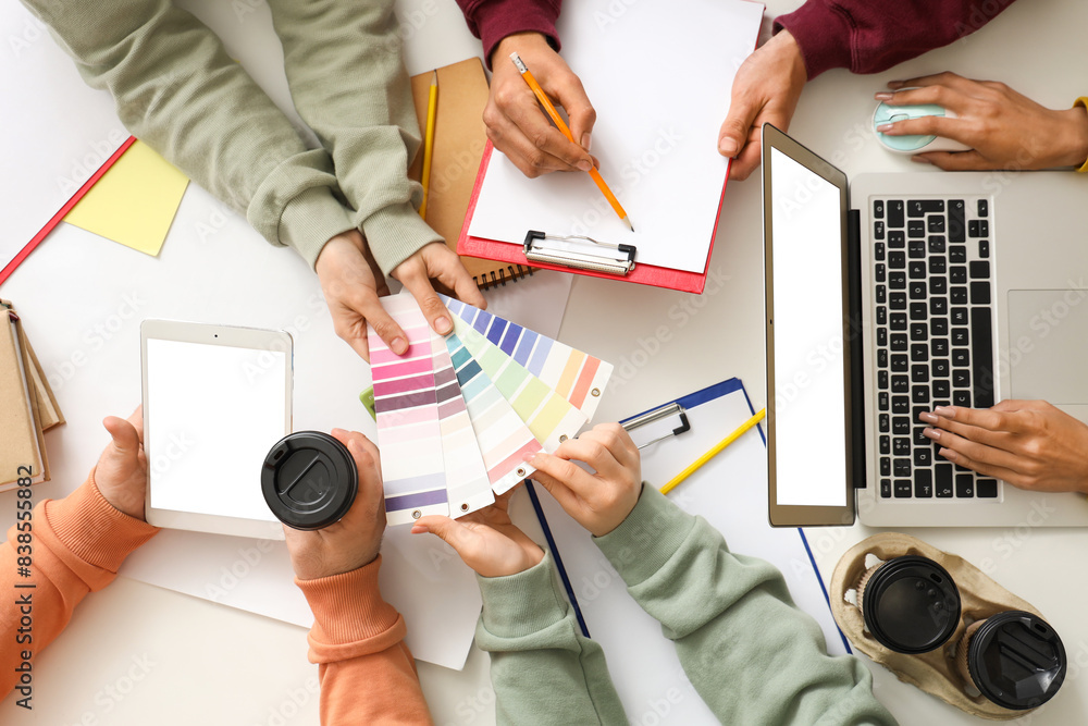Business people working with paint color palettes at white table, top view