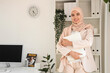 © Pixel-Shot - Beautiful Muslim businesswoman with folder in office