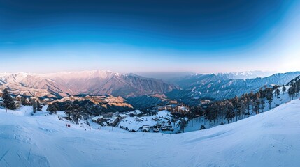 Wall Mural - A panoramic view of the Himalayan mountains covered with snow at sunrise, with a blue sky. A panoramic view from top to bottom, with ski slopes and small huts visible in the distance on a sunny day,