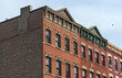 © Yuriy T - jersey city brownstone building detail (historic pre-war red brick buildings with power lines) beautiful real estate apartment homes with cornice decor urban city life window detail close up family