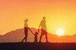 © kieferpix - family walking together at sunset