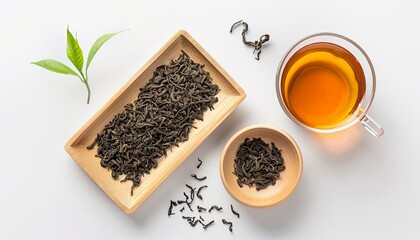 A bowl of tea leaves and a cup of tea sit on a table