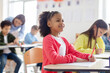 © Home-stock - Back to school. African american schoolgirl pupil student attending school lesson and listening teacher. New academic year semester.