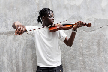 African American young man playing on violin.